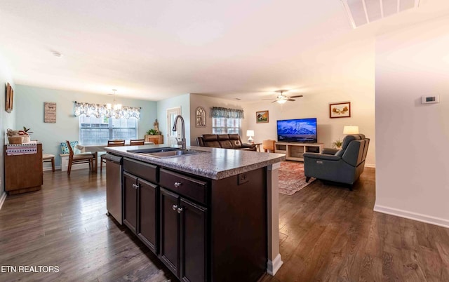 kitchen featuring stainless steel dishwasher, visible vents, dark wood-style flooring, dark brown cabinets, and a sink