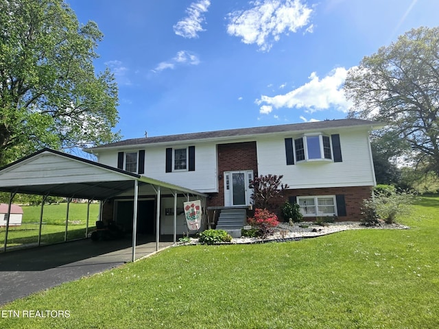 raised ranch with a front lawn, aphalt driveway, and brick siding