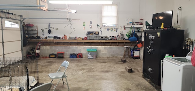 garage with washer / dryer and a workshop area