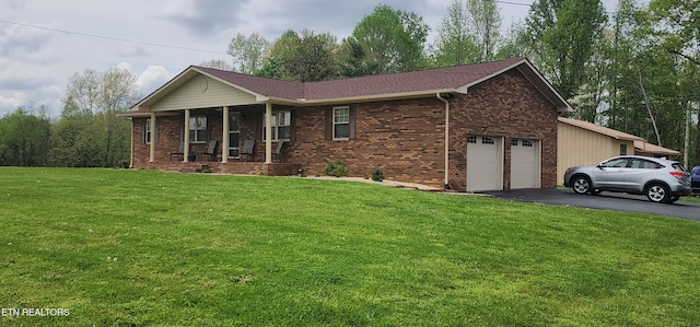 ranch-style house featuring a front lawn, driveway, a porch, brick siding, and a garage
