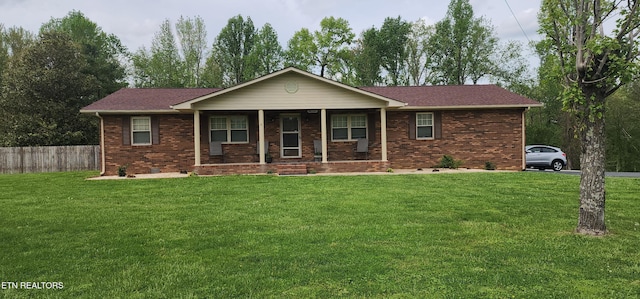 ranch-style house with a front lawn, fence, and a porch