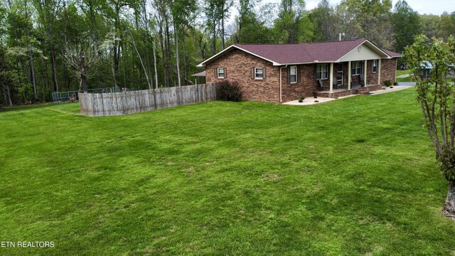 exterior space with a porch and fence