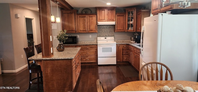 1058 Mountain View Rd, Robbins, TN 37852 - kitchen with white appliances, under cabinet range hood, brown cabinets, dark wood finished floors, and glass insert cabinets