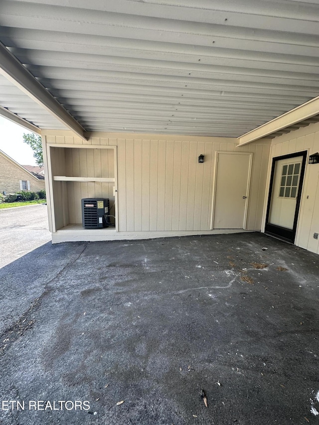 view of patio with central AC unit and a carport