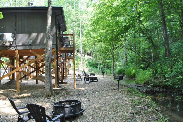 750 Caney Creek Rd, Cosby, TN 37722 - view of yard featuring a view of trees, an outdoor fire pit, and a deck