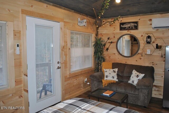 750 Caney Creek Rd, Cosby, TN 37722 - living room with wood finished floors, wood walls, and a wall mounted air conditioner