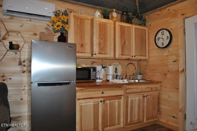 750 Caney Creek Rd, Cosby, TN 37722 - kitchen with stainless steel appliances, an AC wall unit, a sink, light brown cabinetry, and wooden walls