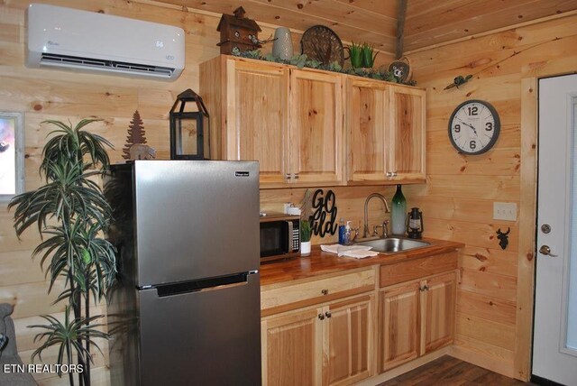 750 Caney Creek Rd, Cosby, TN 37722 - kitchen featuring a wall mounted air conditioner, wood walls, appliances with stainless steel finishes, and a sink
