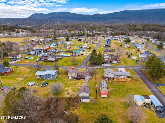 birds eye view of property with a mountain view and a residential view