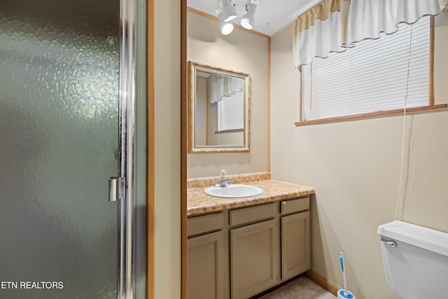 bathroom featuring toilet and vanity