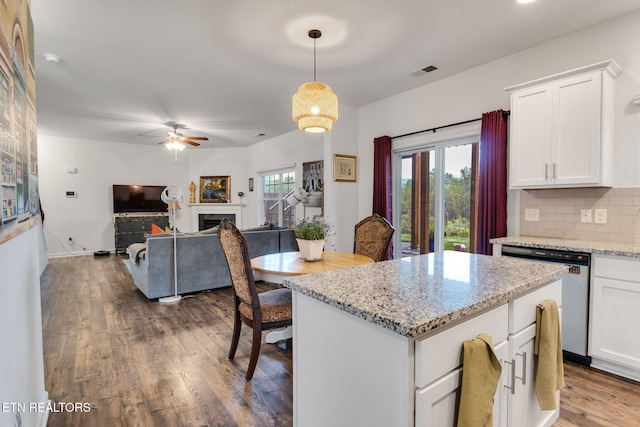 kitchen featuring dark wood finished floors, white cabinets, backsplash, dishwasher, and visible vents