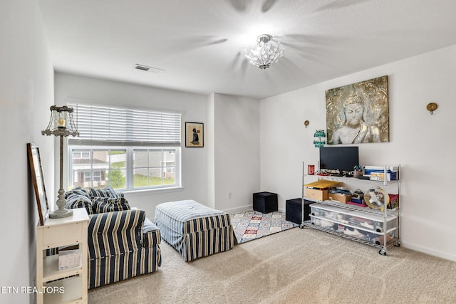 living area with visible vents, carpet flooring, and baseboards