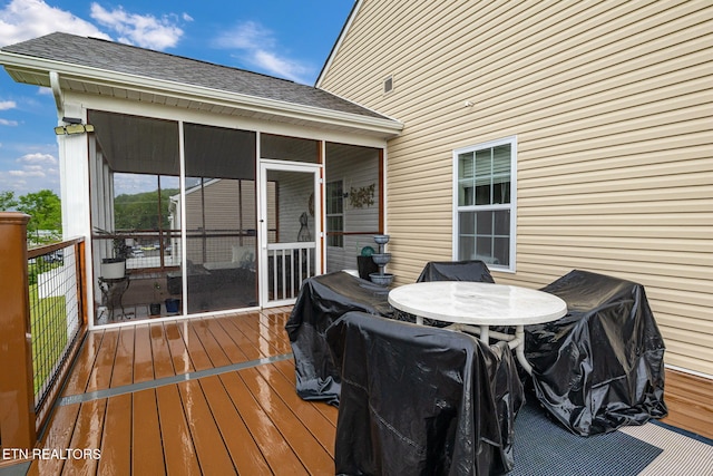 deck with a sunroom