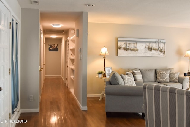 living area featuring dark wood finished floors and baseboards