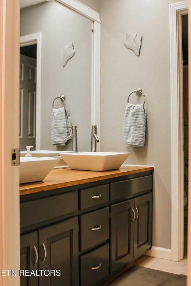 full bath with double vanity and a sink