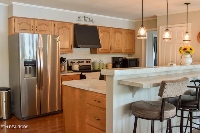 kitchen with a breakfast bar, stainless steel appliances, extractor fan, and light countertops