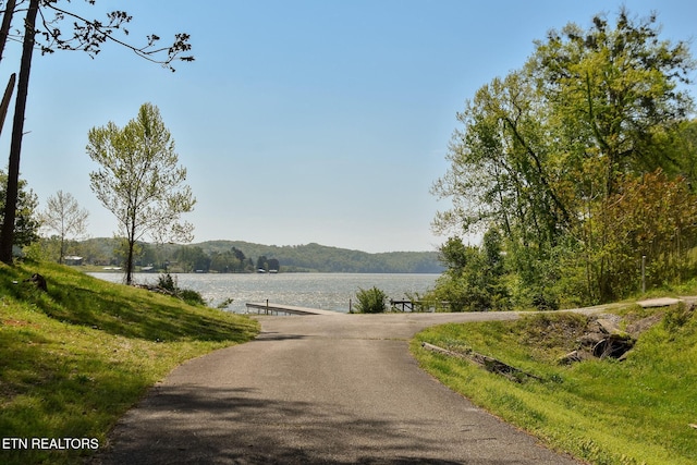 view of street with a water view and a forest view
