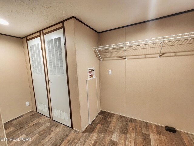 washroom featuring a heating unit, laundry area, hookup for a washing machine, and wood finished floors