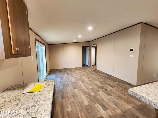 interior space with crown molding, recessed lighting, and wood finished floors