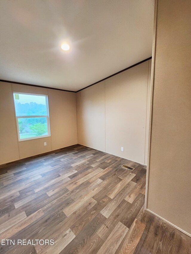 spare room featuring wood finished floors