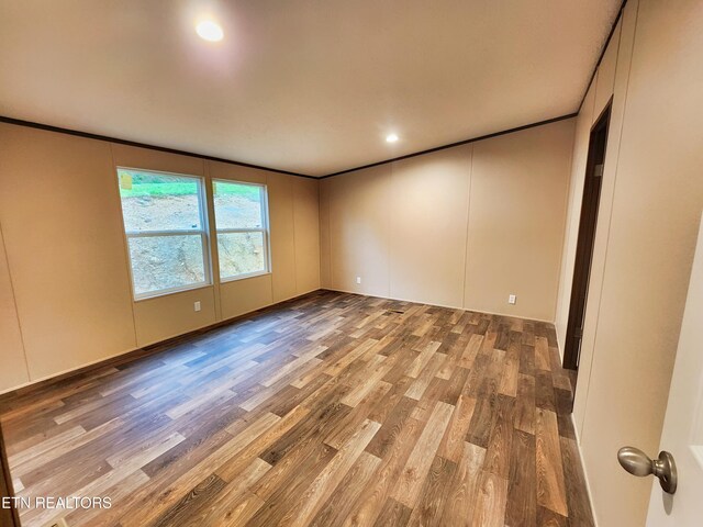 unfurnished room with crown molding, recessed lighting, and wood finished floors