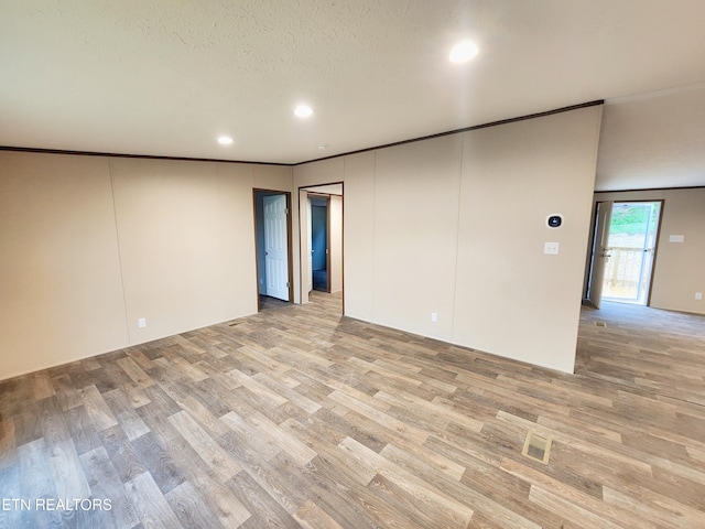 unfurnished room featuring light wood-type flooring, recessed lighting, and ornamental molding