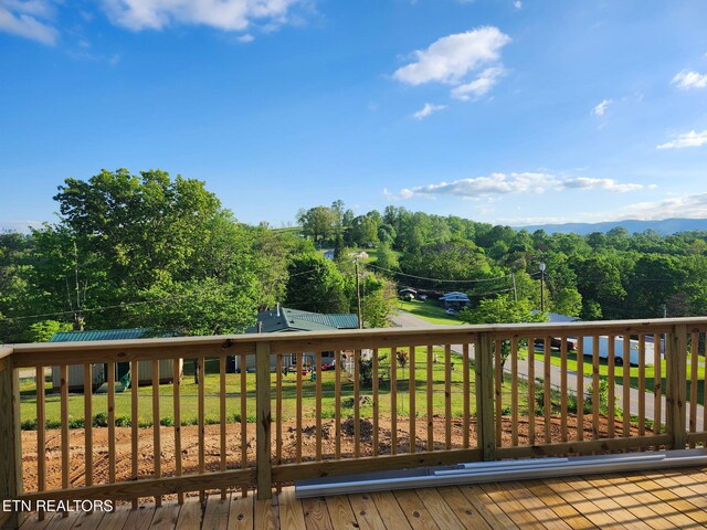 wooden deck with a lawn