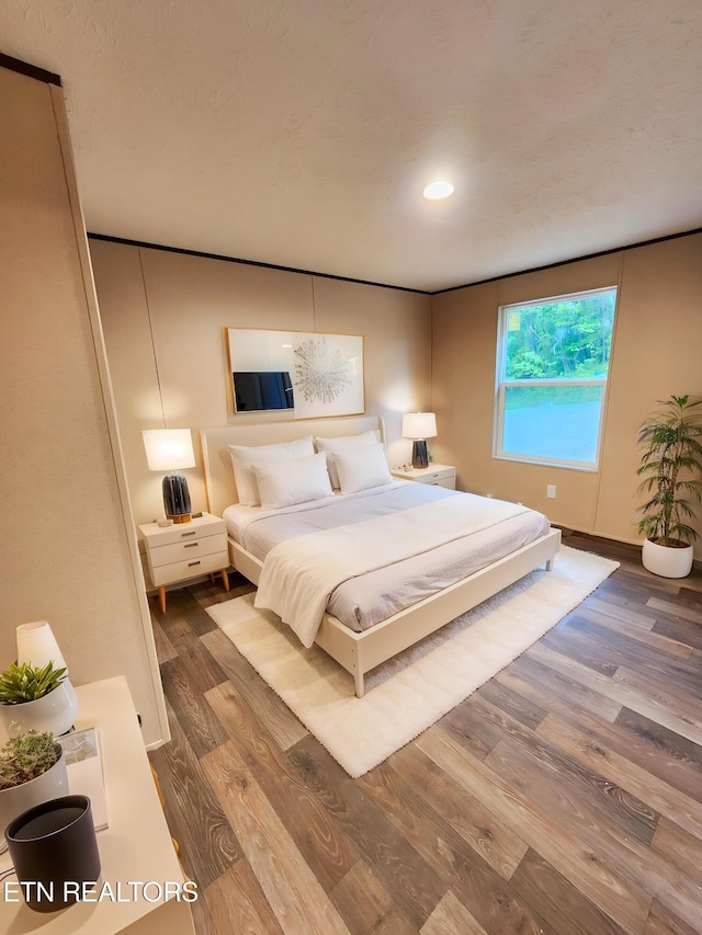 bedroom featuring recessed lighting, baseboards, and wood finished floors