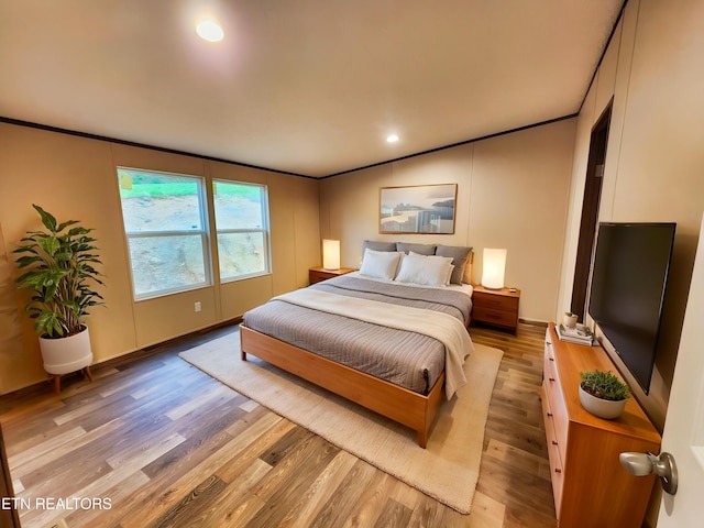 bedroom featuring crown molding, recessed lighting, and light wood-type flooring