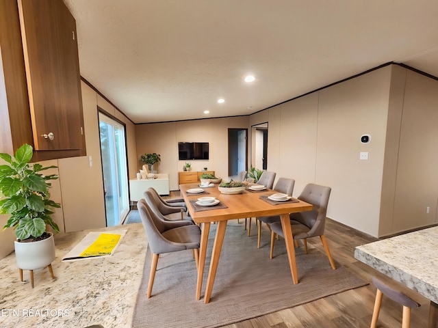 dining space featuring recessed lighting, crown molding, and wood finished floors