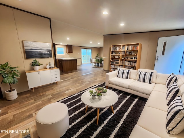 living room with light wood-style floors and recessed lighting