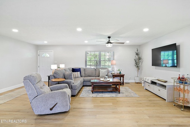 living room with light wood-type flooring, recessed lighting, a ceiling fan, and baseboards