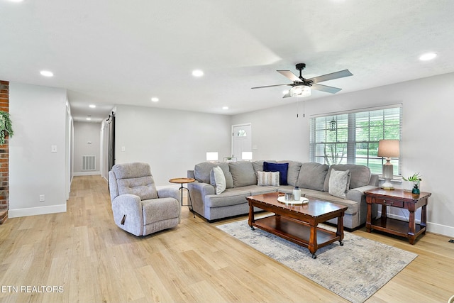 living room featuring light wood-style flooring, visible vents, baseboards, recessed lighting, and a ceiling fan