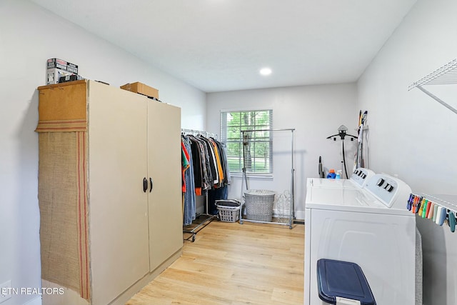laundry room with recessed lighting, separate washer and dryer, light wood-style flooring, and laundry area