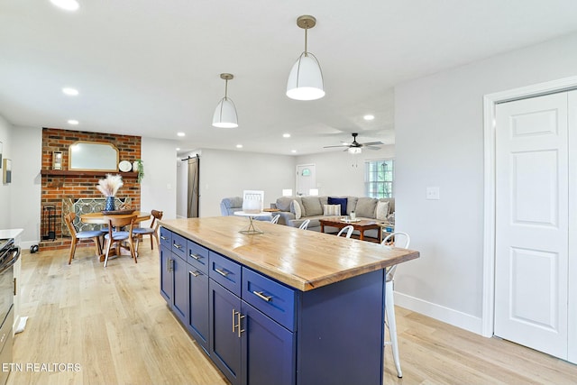 kitchen featuring blue cabinets, recessed lighting, butcher block countertops, light wood-type flooring, and a ceiling fan