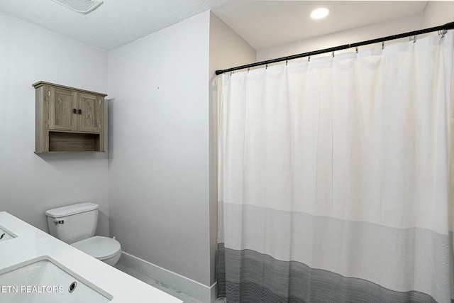 bathroom with recessed lighting, a sink, toilet, visible vents, and baseboards
