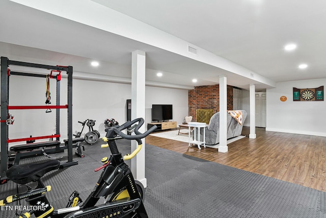 exercise room with recessed lighting, visible vents, wood finished floors, and baseboards