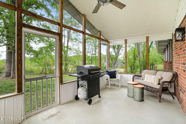 sunroom / solarium with a healthy amount of sunlight, a ceiling fan, and outdoor lounge area