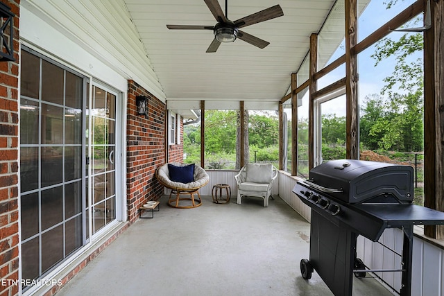 sunroom featuring ceiling fan and a wealth of natural light