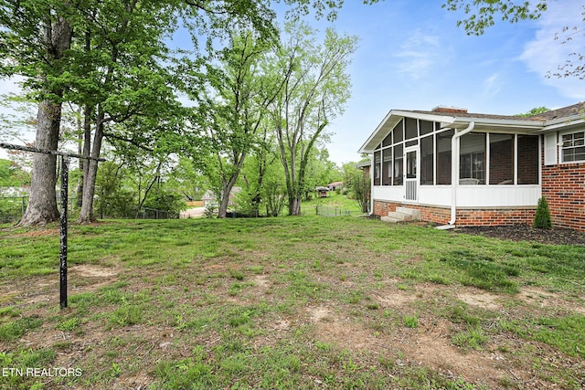 view of yard featuring a sunroom