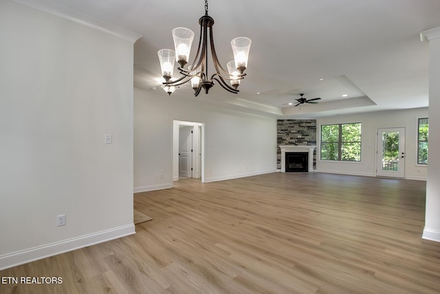 unfurnished living room featuring a tray ceiling, light wood-style flooring, a ceiling fan, baseboards, and recessed lighting