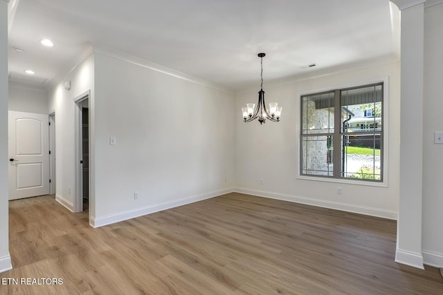 unfurnished dining area featuring ornamental molding, wood finished floors, a chandelier, baseboards, and recessed lighting