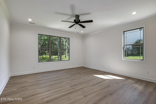spare room with wood finished floors, crown molding, baseboards, ceiling fan, and recessed lighting