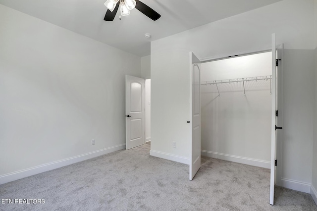 unfurnished bedroom featuring carpet, a closet, a ceiling fan, and baseboards