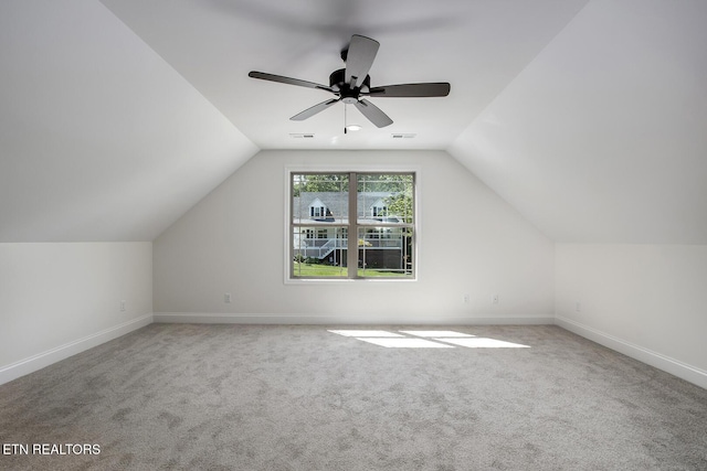 additional living space with carpet floors, baseboards, vaulted ceiling, and a ceiling fan