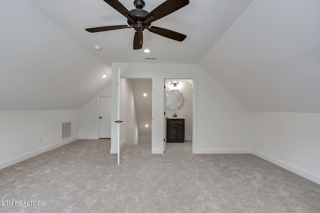 additional living space featuring lofted ceiling, ceiling fan, light carpet, baseboards, and recessed lighting