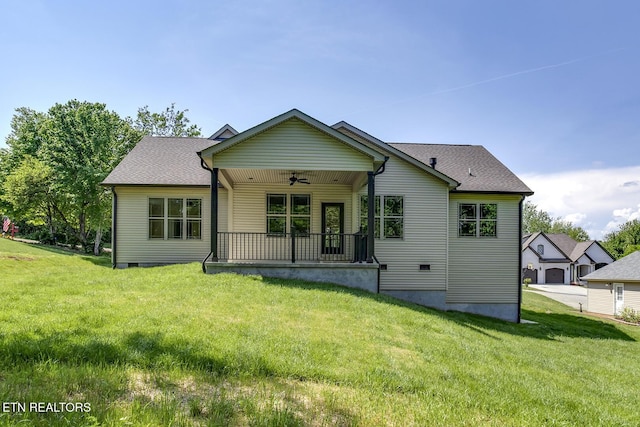 back of property with ceiling fan, a lawn, a porch, and crawl space
