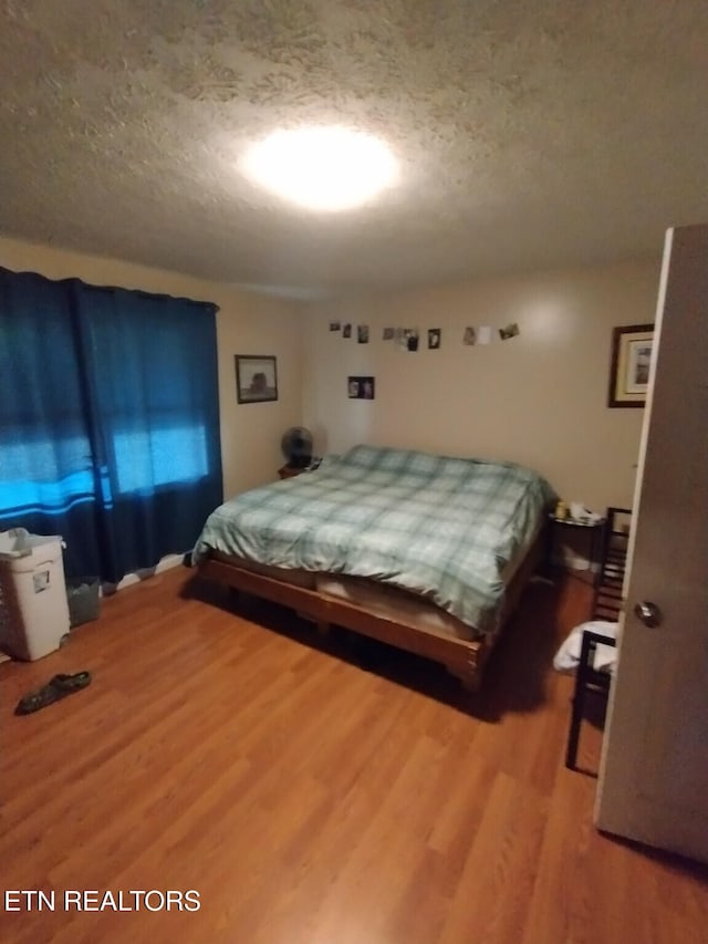 210 Wilson Ave, Mountain City, TN 37683 - bedroom featuring wood finished floors and a textured ceiling