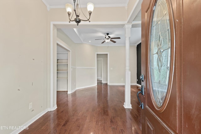 entrance foyer featuring decorative columns, dark wood-type flooring, baseboards, ornamental molding, and ceiling fan with notable chandelier