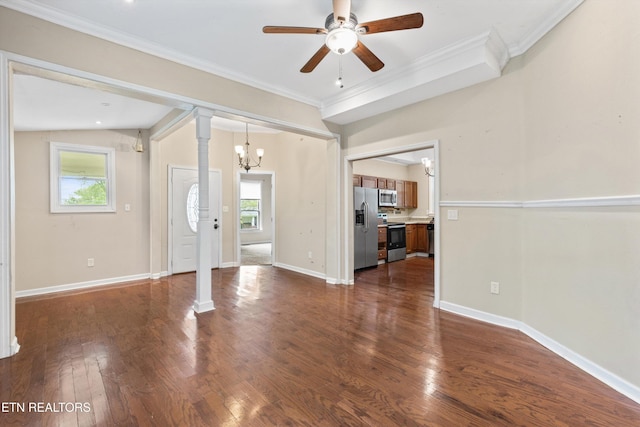 unfurnished living room featuring crown molding, dark wood finished floors, ornate columns, and ceiling fan with notable chandelier